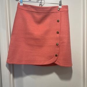 Asymmetrical pink mini skirt with buttons